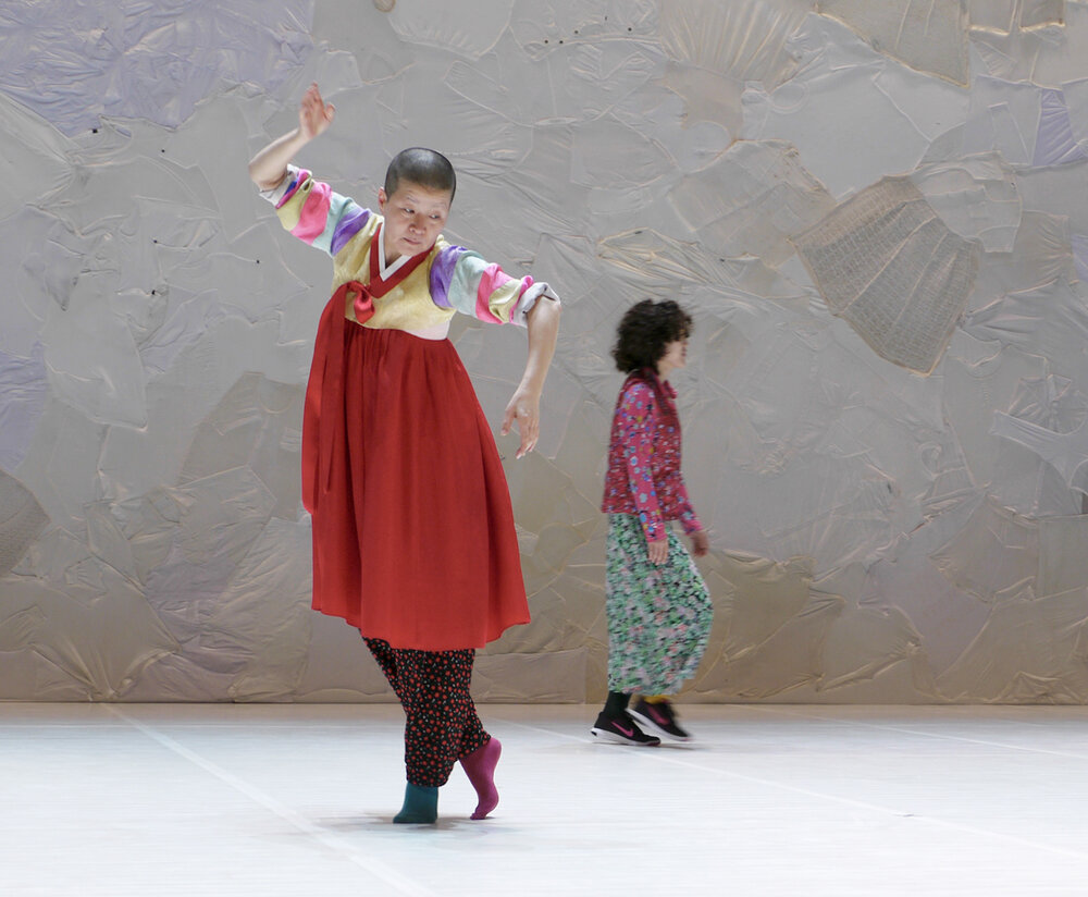 Two people dancing, one is in the foreground